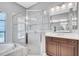 Bathroom featuring a large glass shower enclosure, soaking tub and double-sink vanity offering ample space at 110 167Th E Blvd, Bradenton, FL 34212