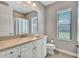 Well-appointed bathroom with a single sink vanity, a shower/tub combo, and window offering natural light at 110 167Th E Blvd, Bradenton, FL 34212