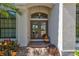 Inviting front entrance with double doors, elegant lighting, and decorative plants at 110 167Th E Blvd, Bradenton, FL 34212