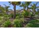 Beautiful home with lush landscaping, trees, and a basketball hoop at 110 167Th E Blvd, Bradenton, FL 34212