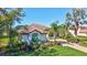 Beautiful single-story home with a lush lawn, a tile roof, and mature landscaping at 110 167Th E Blvd, Bradenton, FL 34212