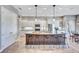 Bright kitchen featuring white cabinets, stainless steel appliances, and a large center island with seating at 110 167Th E Blvd, Bradenton, FL 34212