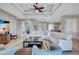Spacious living room boasts tray ceilings, neutral tones, and comfortable white sectional seating area at 110 167Th E Blvd, Bradenton, FL 34212