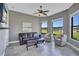 Comfortable living room with a leather sofa, two chairs, tiled floor and a large windows providing lovely views at 110 167Th E Blvd, Bradenton, FL 34212