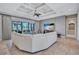 Living room with large sectional, stylish ceiling, and sliding glass doors to the outdoor space at 110 167Th E Blvd, Bradenton, FL 34212