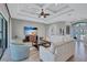 Inviting living room showcases modern ceiling details, neutral tones, large tv, and comfortable seating at 110 167Th E Blvd, Bradenton, FL 34212