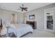 Bedroom with a ceiling fan, TV, a large window and access to the patio at 110 167Th E Blvd, Bradenton, FL 34212