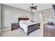 Cozy bedroom featuring a dark wood bed frame and ceiling fan at 110 167Th E Blvd, Bradenton, FL 34212