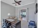 Office space with natural light, neutral tones, ceiling fan, and doorway leading to the living area at 110 167Th E Blvd, Bradenton, FL 34212
