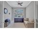 A well-lit home office with a large window, built-in desk, and comfortable seating at 110 167Th E Blvd, Bradenton, FL 34212