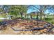 Playground with swings and slides, plus a shaded pavilion with picnic tables in a grassy park at 110 167Th E Blvd, Bradenton, FL 34212