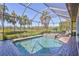 Gorgeous screened-in pool and spa, surrounded by well-manicured lawn and tropical foliage at 110 167Th E Blvd, Bradenton, FL 34212