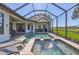Stunning screened-in pool and spa with water feature, perfect for relaxing outdoors at 110 167Th E Blvd, Bradenton, FL 34212
