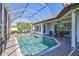 Amazing screened-in pool area with spa, outdoor seating, and well-maintained landscaping at 110 167Th E Blvd, Bradenton, FL 34212