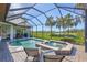 Beautiful screened-in pool and spa with lush landscaping and tranquil water views at 110 167Th E Blvd, Bradenton, FL 34212