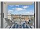 Enjoy city views from this beautiful balcony with outdoor seating and blue striped outdoor rug at 111 S Pineapple Ave # 918, Sarasota, FL 34236