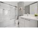 Bathroom with a sleek white vanity, modern fixtures, and a glass-enclosed shower-over-tub for a clean and contemporary design at 111 S Pineapple Ave # 918, Sarasota, FL 34236