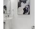 Bright half-bathroom featuring pedestal sink and modern art at 111 S Pineapple Ave # 918, Sarasota, FL 34236