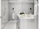 Bright bathroom features marble floors, a modern vanity with double sinks, and a glass shower at 111 S Pineapple Ave # 918, Sarasota, FL 34236