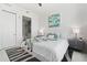 Modern bedroom featuring a luxurious bed, stylish nightstands, and ensuite bathroom at 111 S Pineapple Ave # 918, Sarasota, FL 34236