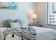Close-up of bed with many pillows, soft blanket, and a great side table at 111 S Pineapple Ave # 918, Sarasota, FL 34236