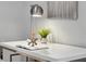 Close-up of a modern white desk with decorative items, ample lighting, and stylish accessories for a productive workspace at 111 S Pineapple Ave # 918, Sarasota, FL 34236
