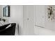Bright hallway featuring white walls, white floors, and a modern console table at 111 S Pineapple Ave # 918, Sarasota, FL 34236