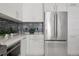 Contemporary kitchen design with white cabinets, stainless steel refrigerator, and mosaic tile backsplash at 111 S Pineapple Ave # 918, Sarasota, FL 34236
