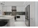 Modern kitchen featuring white cabinetry, stainless steel appliances, and an island with bar seating at 111 S Pineapple Ave # 918, Sarasota, FL 34236