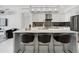 Open-concept kitchen with a central island, stainless steel appliances, and elegant lighting at 111 S Pineapple Ave # 918, Sarasota, FL 34236