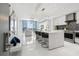 Bright open-concept kitchen with an island, modern appliances, and expansive windows showcasing city views at 111 S Pineapple Ave # 918, Sarasota, FL 34236