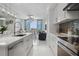 Open concept kitchen with an island and stainless steel appliances offers seamless flow to the living area at 111 S Pineapple Ave # 918, Sarasota, FL 34236