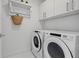 Well-organized laundry room featuring a washer and dryer, storage shelves, and ample space for laundry tasks at 111 S Pineapple Ave # 918, Sarasota, FL 34236