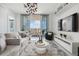 Bright living room with modern decor, stylish furnishings, and a sliding door leading to a balcony with city views at 111 S Pineapple Ave # 918, Sarasota, FL 34236