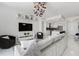 Open-concept living space with elegant furnishings, a statement chandelier, and a modern entertainment unit enhancing the ambiance at 111 S Pineapple Ave # 918, Sarasota, FL 34236