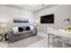 Cozy living room featuring a comfortable gray sofa, stylish decor, a modern lamp, and a sleek desk area with contemporary furnishings at 111 S Pineapple Ave # 918, Sarasota, FL 34236