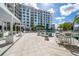 Inviting pool deck features modern outdoor seating, umbrellas, and a backdrop of beautiful palms and architecture at 111 S Pineapple Ave # 918, Sarasota, FL 34236