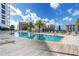 Resort-style pool with lounge chairs, umbrellas, and well manicured surroundings at 111 S Pineapple Ave # 918, Sarasota, FL 34236