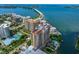 Stunning aerial view of waterfront condos, bay, and bridge offering luxury living and breathtaking scenery at 1111 Ritz Carlton Dr # 1704, Sarasota, FL 34236