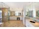 Bright bathroom features a glass enclosed shower, double vanity, tile flooring, lots of mirrors and natural light at 1111 Ritz Carlton Dr # 1704, Sarasota, FL 34236