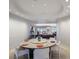 Bright dining room features a modern round table, recessed lights, and a view into the living space at 1111 Ritz Carlton Dr # 1704, Sarasota, FL 34236