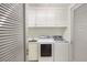 Convenient laundry room with washer, dryer, and ample storage at 1111 Ritz Carlton Dr # 1704, Sarasota, FL 34236