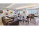 Spacious living room with modern art, comfortable seating, and balcony access offering city views at 1111 Ritz Carlton Dr # 1704, Sarasota, FL 34236