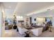 Open living room with a fireplace, stylish seating, and built-in shelves creating a cozy atmosphere at 1111 Ritz Carlton Dr # 1704, Sarasota, FL 34236