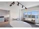 Home office with a large window showing a view of the city and water and modern track lighting at 1111 Ritz Carlton Dr # 1704, Sarasota, FL 34236