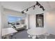 Home office with a large window showing a view of the city and water, large desks and modern track lighting at 1111 Ritz Carlton Dr # 1704, Sarasota, FL 34236