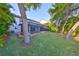 Expansive backyard with lush greenery, mature trees, and screened-in pool area, perfect for outdoor living at 11408 Drifting Leaf Dr, Riverview, FL 33579