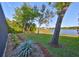 Picturesque backyard with mature landscaping, a tranquil lake view, and a well-maintained lawn at 11408 Drifting Leaf Dr, Riverview, FL 33579