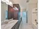 Bright bathroom featuring granite counters, ample cabinets, and shower-tub combination at 11408 Drifting Leaf Dr, Riverview, FL 33579