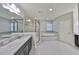 Spacious bathroom featuring double sinks, a walk-in shower, and a soaking tub at 11408 Drifting Leaf Dr, Riverview, FL 33579